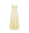 Yellow dress with thin straps on a white background