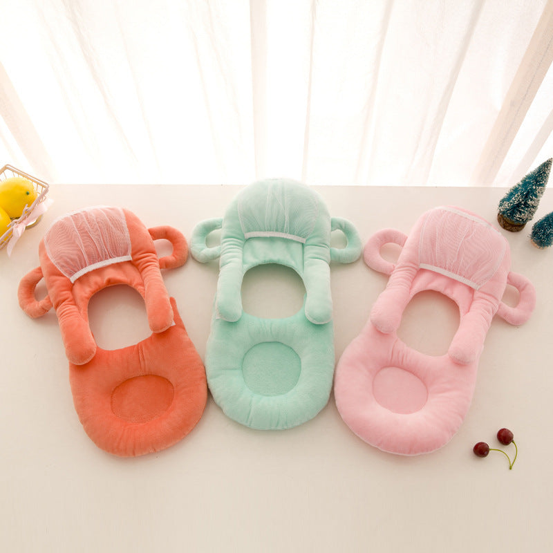 Soft plush baby feeding pillow with ergonomic anti-spit design, available in pink, purple, green
