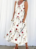 White sleeveless dress with red floral pattern worn by a person against a white background