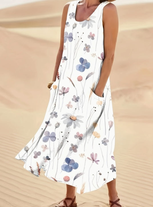 Woman wearing a floral dress standing in sand dunes