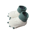 Pair of white slippers with green ribbed tops on a white background