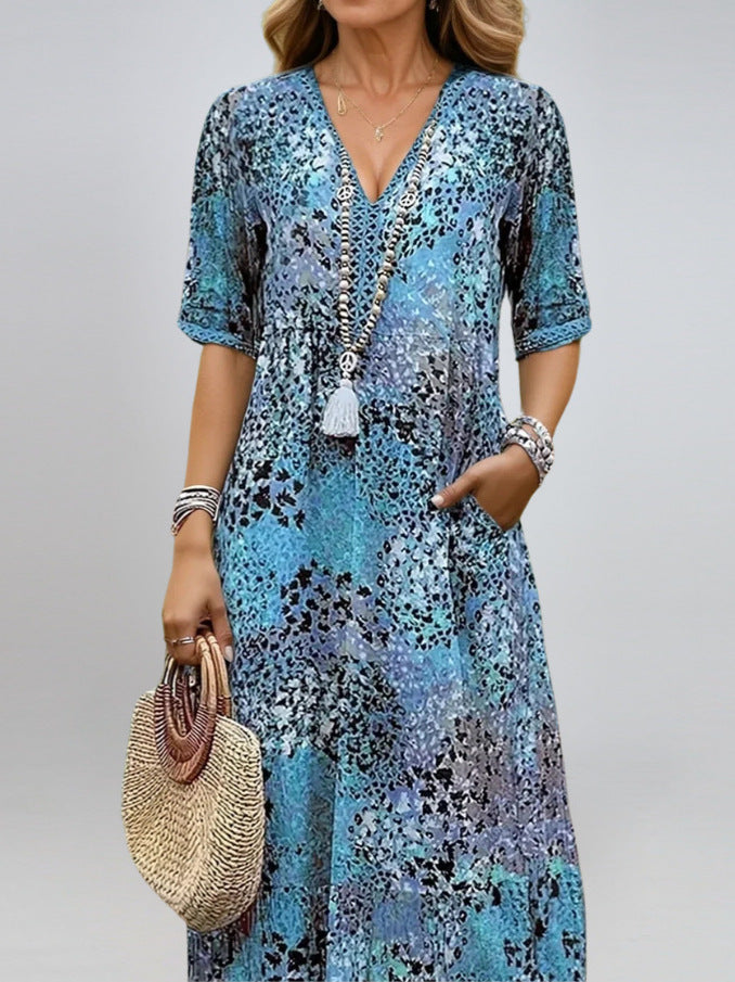 Woman wearing a summer V-neck half-sleeve ethnic print dress with pockets on a sunny beach day